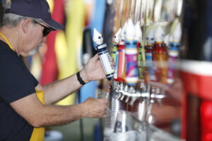 A worker pouring a beer from the tap